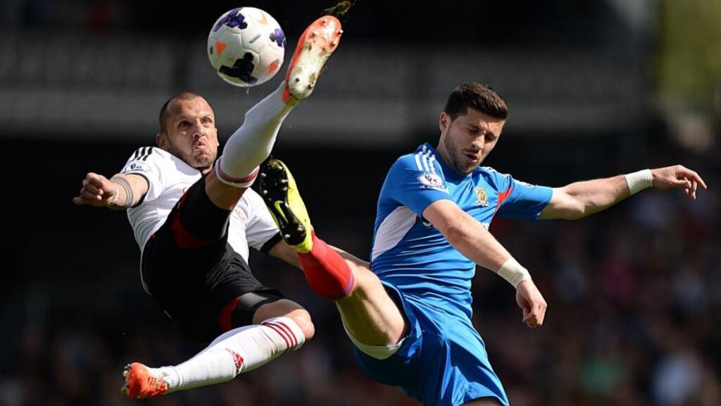 Hull City’s Shane Long (right) and Fulham’s Johnny Heitinga (left) battle for possession. Photograph: Andrew Matthews/PA Wire