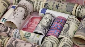 Dollar edges off lows over expectations of a rate hike