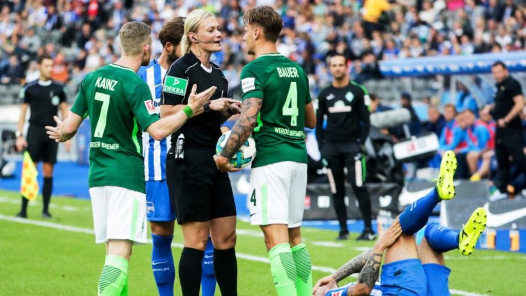 Referee Bibiana Steinhaus talks to Bremen’s Robert Bauer (right) while Florian Kainz reacts during the German Bundesliga soccer match between Hertha BSC and Werder Bremen at the Olympic Stadium in Berlin. Photograph: Carsten Koall/EPA