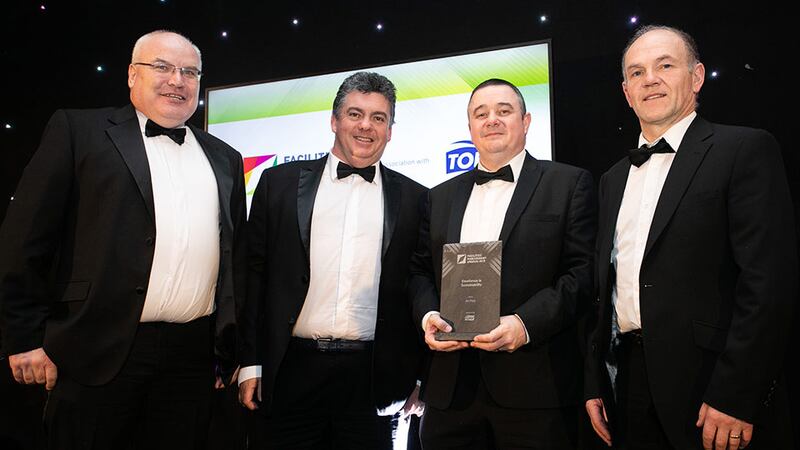 TJ Fox, National Business Development Manager, Tork, an Essity brand presents the Excellence in Sustainability award to the An Post Team.