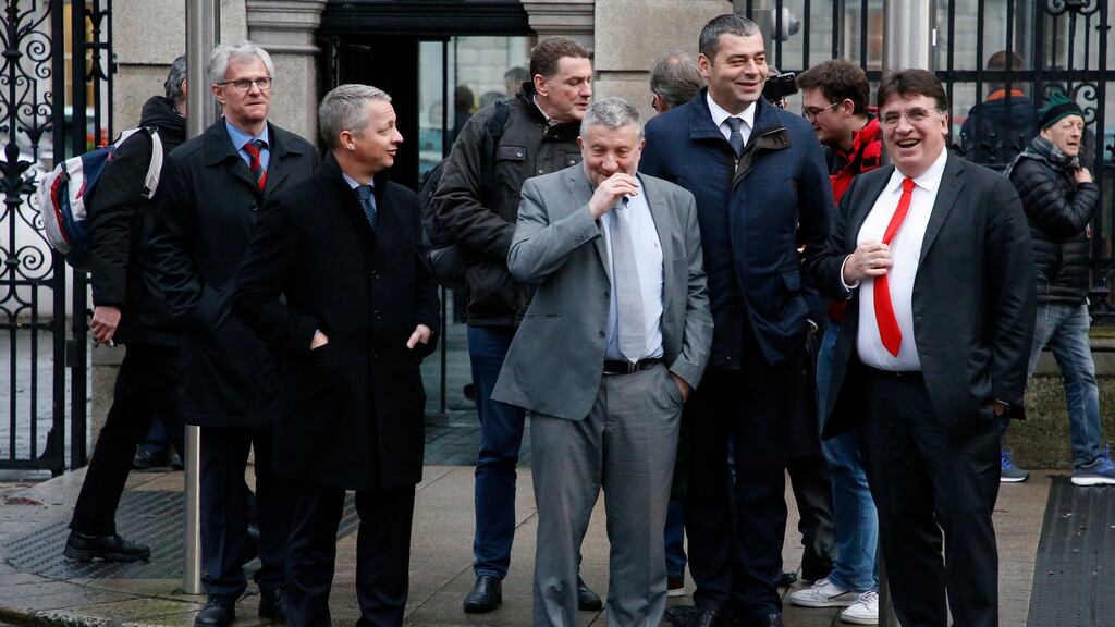 FAI executive lead Paul Cooke (grey suit) with members of the Uefa delegation, including general secretary Theodore Theodoridis (red tie) outside Leinster House on Tuesday. Photograph: Nick Bradshaw