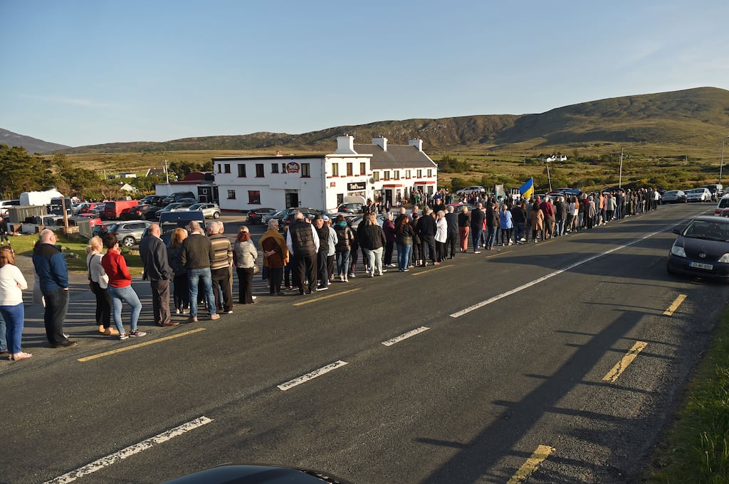 Mourners gather outside Ted Lavelle's pub to offer condolonces to the family and friends of Finbar Cafferkey on Friday evening. Photograph: Conor McKeown