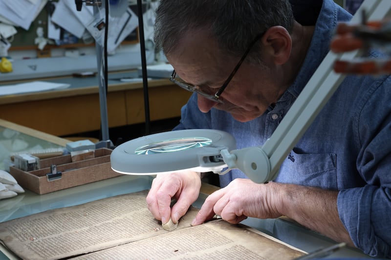 John Gillis who led the conservation project, with the 12th Century Book of Leinster. Photograph: Dara Mac Dónaill
