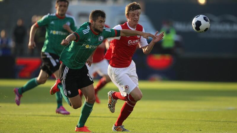 Legia Warsaw’s Lukasz Broz and St. Patrick’s Christopher Forrester compete for possession during the Champions League Second Qualifying Round match at Tallaght Stadium last night. Photograph: Niall Carson/PA Wire.
