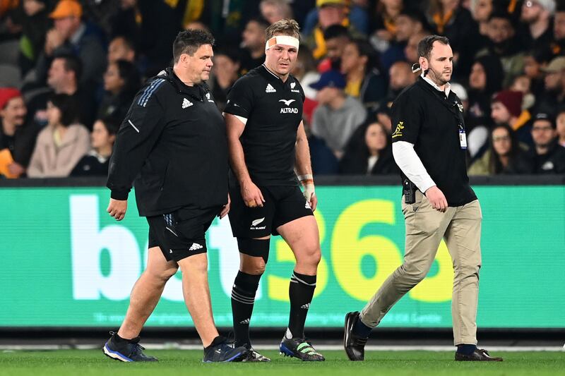Sam Cane of the All Blacks leaves the field for a concussion test during a clash with Australia in 2022. Photograph: Hannah Peters/Getty Images