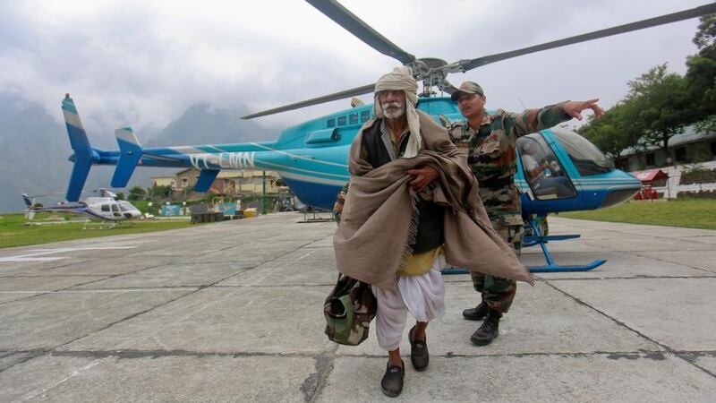 A man is guided by a soldier during a rescue operation at Joshimath. Photograph: Danish Siddiqui/Reuters