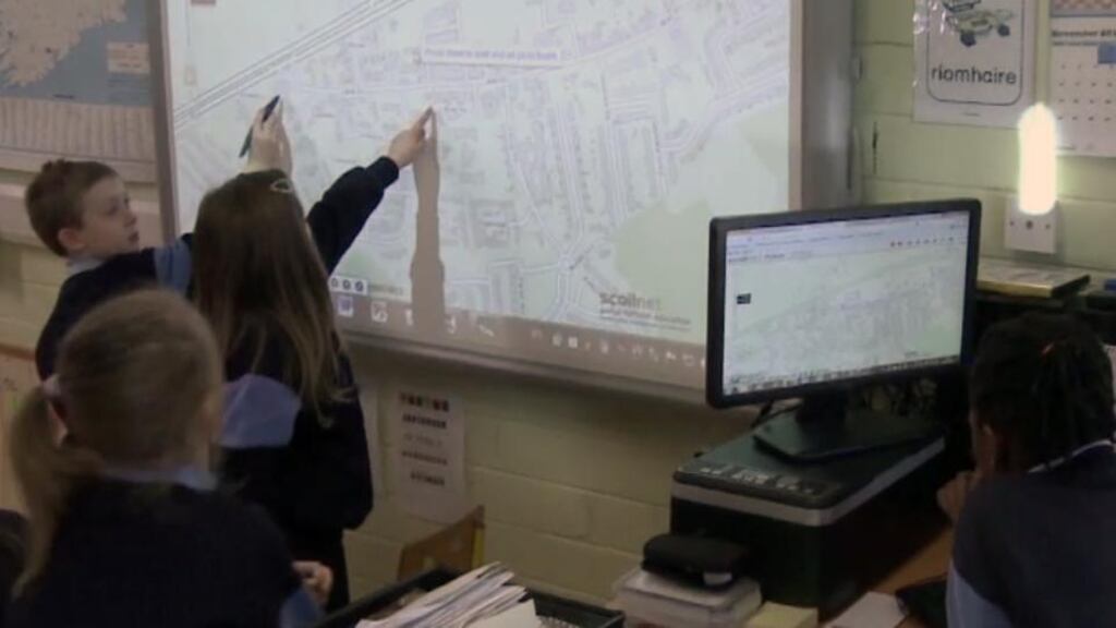 Schoolchildren looking at the maps on the big screen