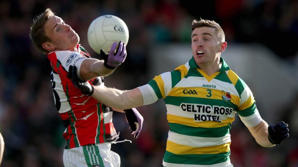 Ballincollig’s John Kelly battles Brian Shanahan of Carbery Rangers for possession in yesterday’s Cork senior football final. Photograph: Donall Farmer/Inpho