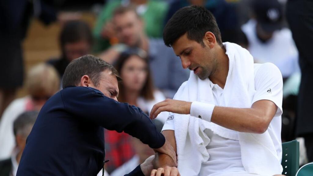 Novak Djokovic of Serbia is given treatment during his men’s singles quarter final match against Tomas Berdych on day nine of the Wimbledon Lawn Tennis Championships. Photo: Julian Finney/Getty Images