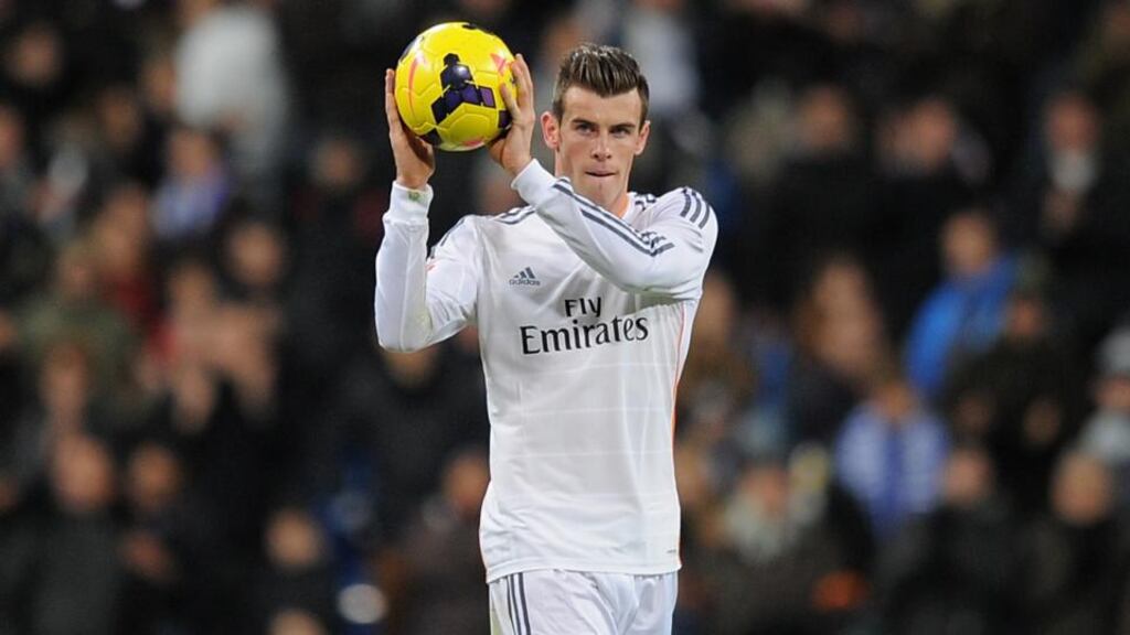 Gareth Bale  takes away the match ball after scoring his first hat-trick for Real Madrid  at the end of the La Liga match between against Real Valladolid  at the  Bernabeu stadium in Madrid. Photograph: Denis Doyle/Getty Images