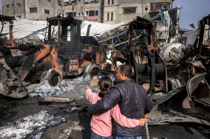 People inspect destroyed bulldozers and other heavy vehicles at the Jabalia municipality garage, which was hit by Israeli bombardment, in Jabalia in the northern Gaza Strip last week. Photograph: Bashar Taleb/AFP via Getty Images