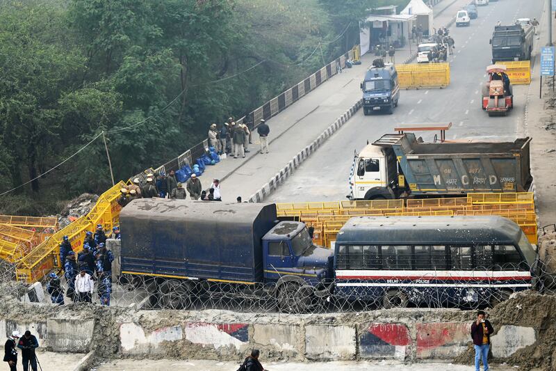 Security personnel stand guard at a road block at the Ghazipur New Delhi-Uttar Pradesh state border during a nationwide strike called by farmers. Photograph: Sajjad Hussain/AFP via Getty Images
