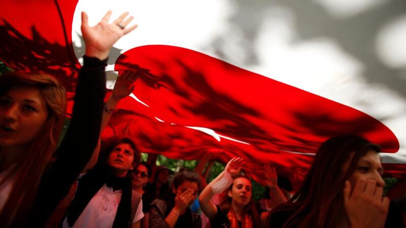 Protesters carry the Turkish flag and shout anti-government slogans during a demonstration at Gezi Park near Taksim Square in central Istanbul today. Photograph: Stoyan Nenov/Reuters