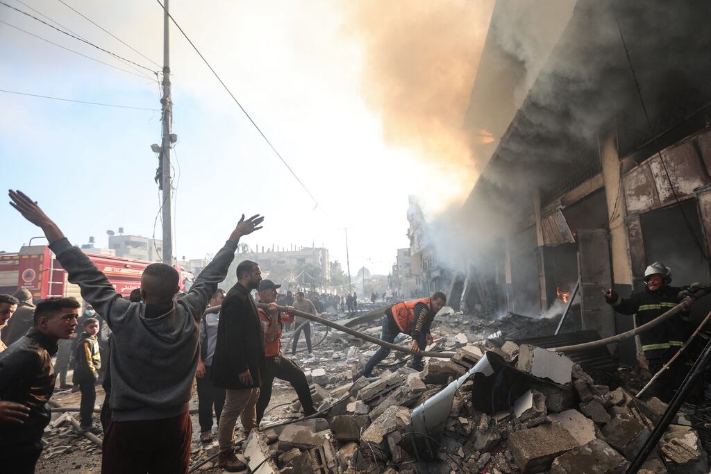 People watch as firefighters battle flames in a building hit by an Israeli strike in Khan Younis in the southern Gaza Strip on Saturday. Photograph: by AFP via Getty Images