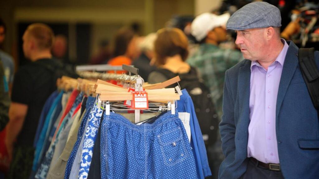 A shopper looks through clothes at the liquidation sale in a premises on Parnell Street, Dublin. Photograph: Aidan Crawley