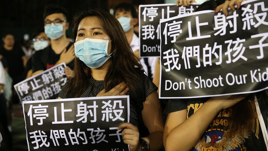Protesters take part in a rally accusing the police of using excessive force, in Hong Kong on Wednesday. Photograph: Jerome Favre/EPA