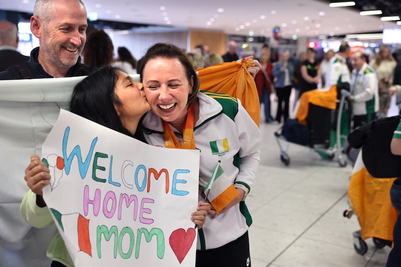 Mairead O’ Mahony welcomed home by her husband Tony and daughter Isabella at Dublin Airport. Photograph: Dara Mac Dónaill