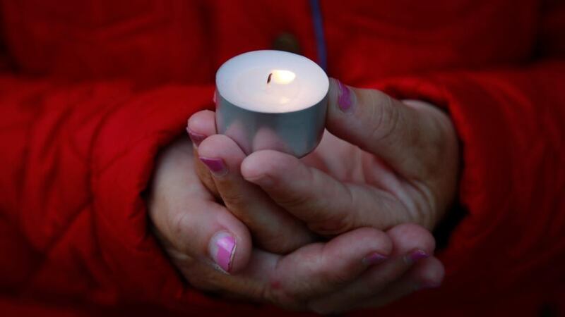 Vigil: a woman holds a candle for Shane “Jack” Watson, before details of his past became public.  Photograph: Nick Bradshaw