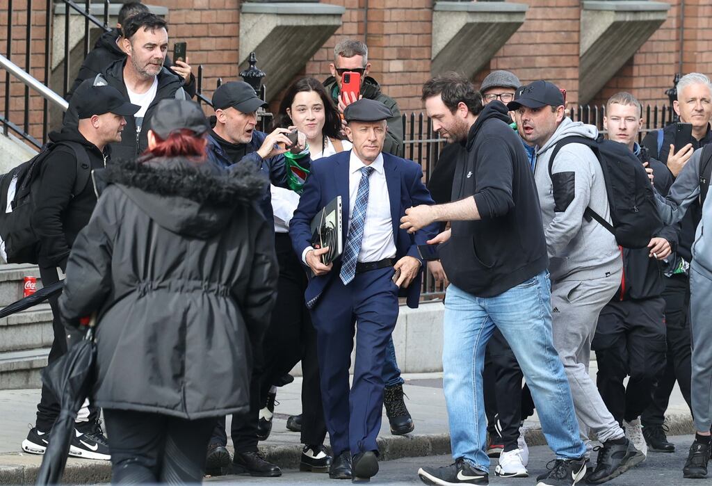 TD Michael Healy-Rae and Abby Caballero, his new assistant, are surrounded by protesters outside Leinster House on Wednesday. 'It became serious really quick. It was crazy,' says Ms Caballero, Photograph: Sam Boal/RollingNews.ie