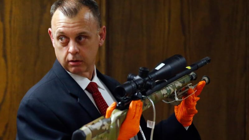 Texas Ranger Michael Adcock holds one of the rifles received from the crime scene during the murder trial. Photograph: Mike Stone/Reuters