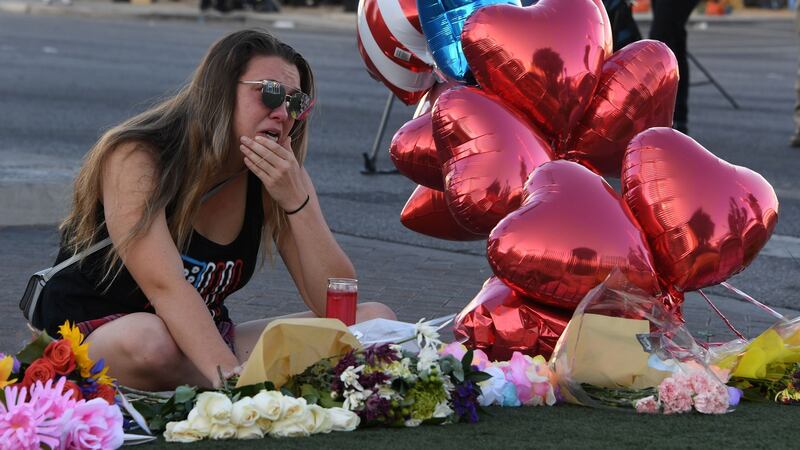 Destiny Alvers at a makeshift memorial on the Las Vegas Strip. She was at the Route 91 country music festival when Stephen Paddock opened fire on the crowd, and helped rescue her friend who was shot. Photograph: Mark Ralston/AFP/Getty Images