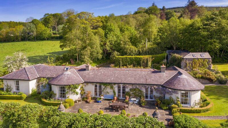An old parapet, which once graced a house on Thomas Street in Dublin, frames the old slate flagstone patio