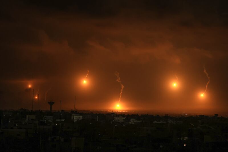 Israeli flares light the sky above Khan Yunis in the southern Gaza Strip, on Friday, as fighting resumed after the expiration of a seven-day truce between Israel and Hamas militants. Photograph: Said Khatib/AFP via Getty Images