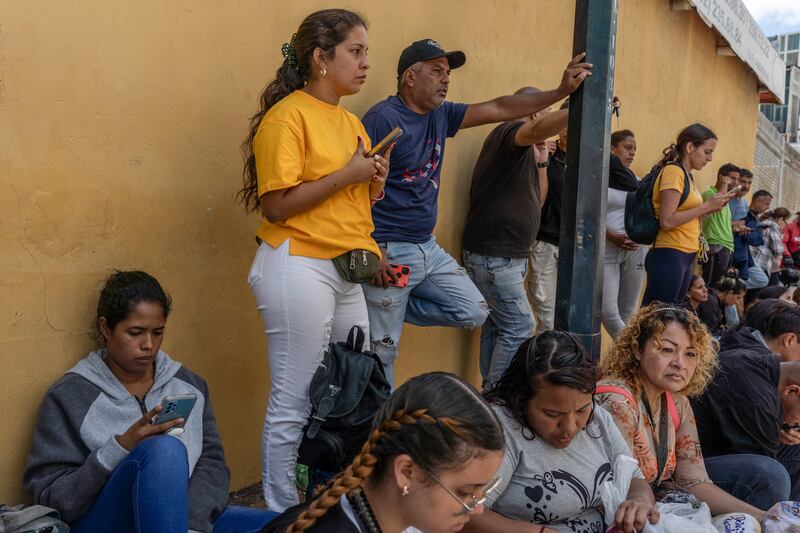 Family members of detained protesters wait outside a detention centre in Caracas, Venezuela. Photograph: Alejandro Cegarra/The New York Times