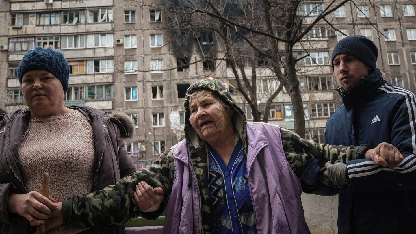 People assist an elderly woman after an apartment building was hit by shelling, in Mariupol, Ukraine. Photograph: Evgeniy Maloletka/AP Photo