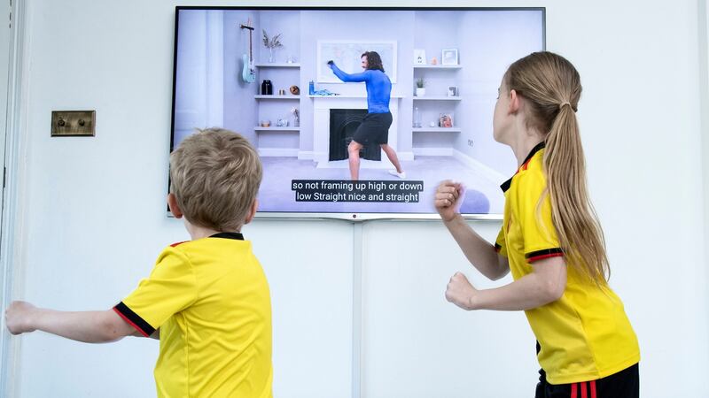 Mia, aged 8, and Jack, aged 5, take part in ‘PE with Joe’ a daily live workout with Joe Wicks on YouTube. Photograph:Ian West/PA Wire