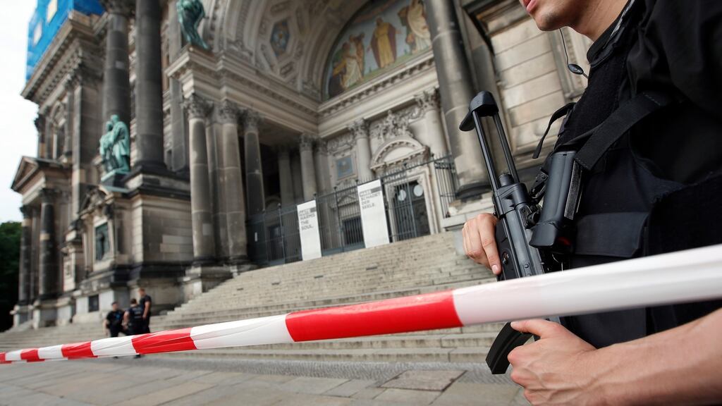 A police officer with a gun stands in front of the Berlin Cathedral, in Germany. Photograph: AP Photo/Michael Sohn