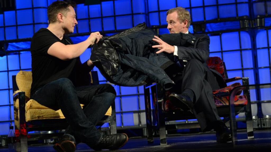 Paypal founder Elon Musk hands his jacket to Enda Kenny at the Web Summit, in the RDS Dublin. Photograph: Dara Mac Dónaill/The Irish Times