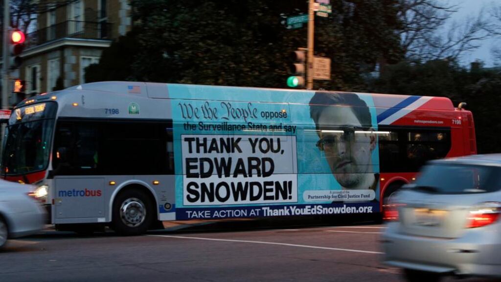 A Washington Metro bus is seen with an Edward Snowden sign on its side panel last week. Photograph: Gary Cameron/Reuters