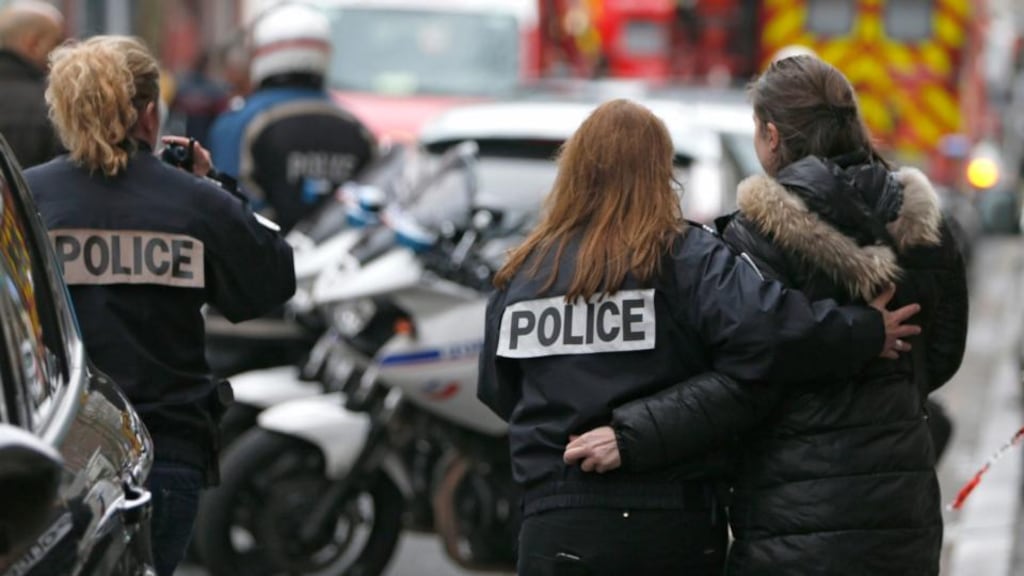 French police help a woman after a shooting in the street of Montrouge near Paris on Thursday. Photograph: Charles Platiau/Reuters