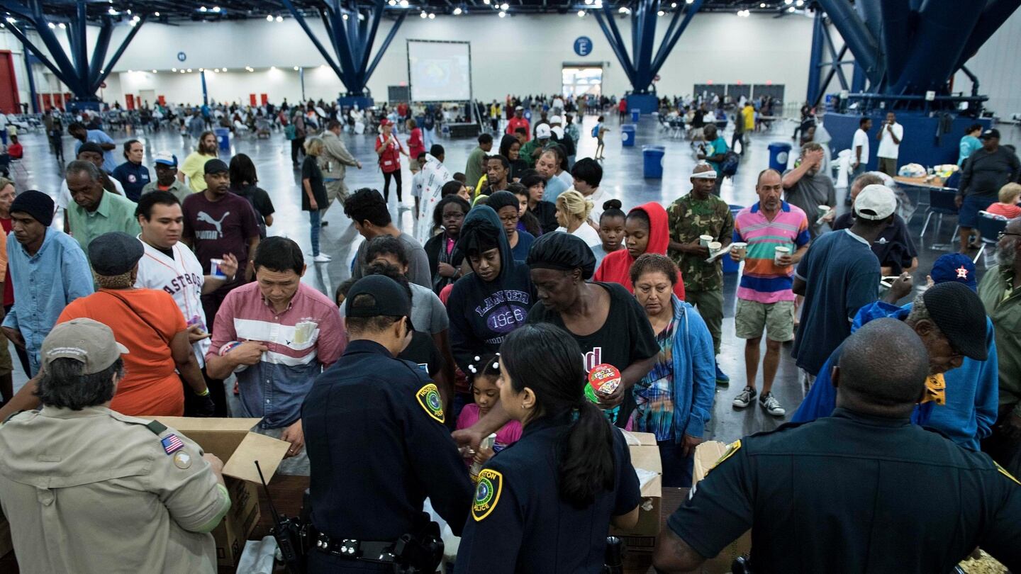 Flood victims gather for food at a shelter in the George R Brown Convention Centre, in Houston, Texas, the US. Photograph: Brendan Smialowski/AFP/Getty Images