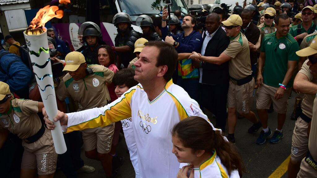 Mayor of Rio Eduardo Paes carries the Olympic torch ahead of the Rio 2016 Olympic Games in Rio de Janeiro on August 3rd, 2016. Photograph: Tasso Marcelot/AP