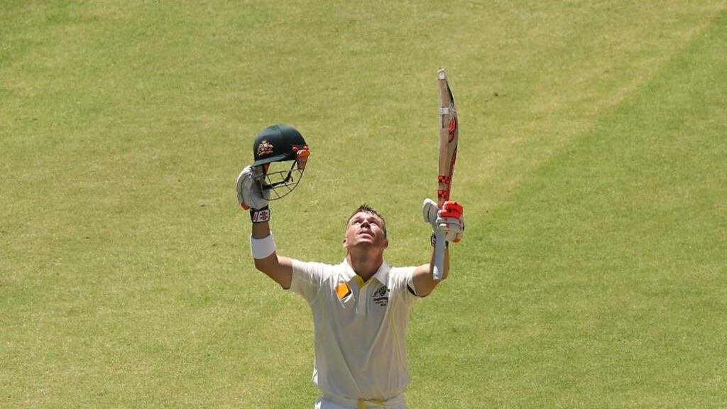 Australia’s David Warner looks to the sky after reaching his century during day one of the opening test match against India at Adelaide