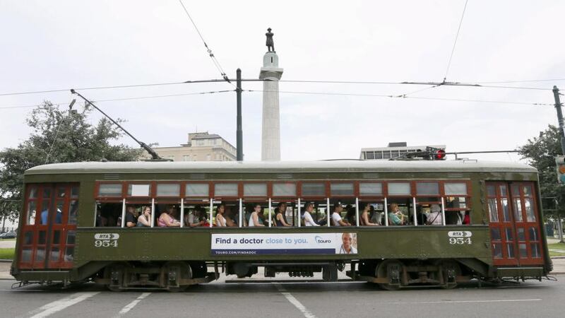 A streetcar passes by a monument to Confederate General Robert E Lee at a traffic circle in New Orleans, Louisiana. Photograph: Jonathan Bachman/Reuters