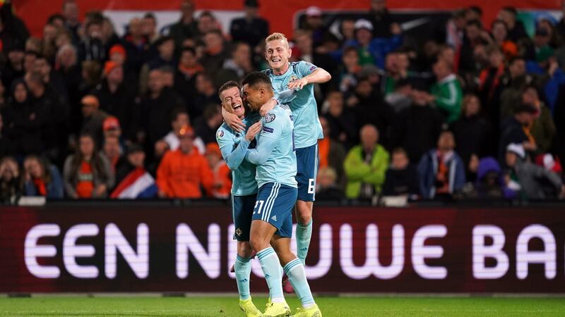 Northern Ireland’s Josh Magennis celebrates opening the scoring with Steven Davis and George Saville during the Euro 2020 Group C match at the Feyenoord Stadium in Rotterdam. Photograph: John Walton/PA Wire