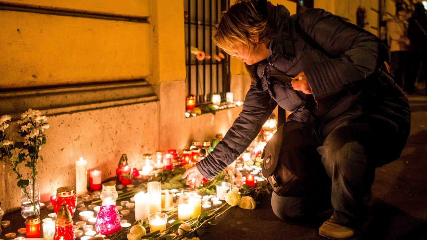 A mourner lights a candle to the memory of the victims of the school bus crash in Italy. Photograph: EPA