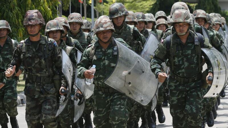 Thai soldiers guard in the area during a meeting between the army and the main political rivals at the Army Club in Bangkok. Photograph: Narong Sangnak/EPA