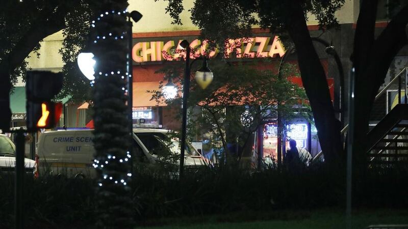 A crime scene unit van is seen as police investigate a shooting at the GLHF Game Bar, which uses the same entrance as the Chicago Pizza place at the Jacksonville Landing in Florida. Photograph: Joe Raedle/Getty Images.