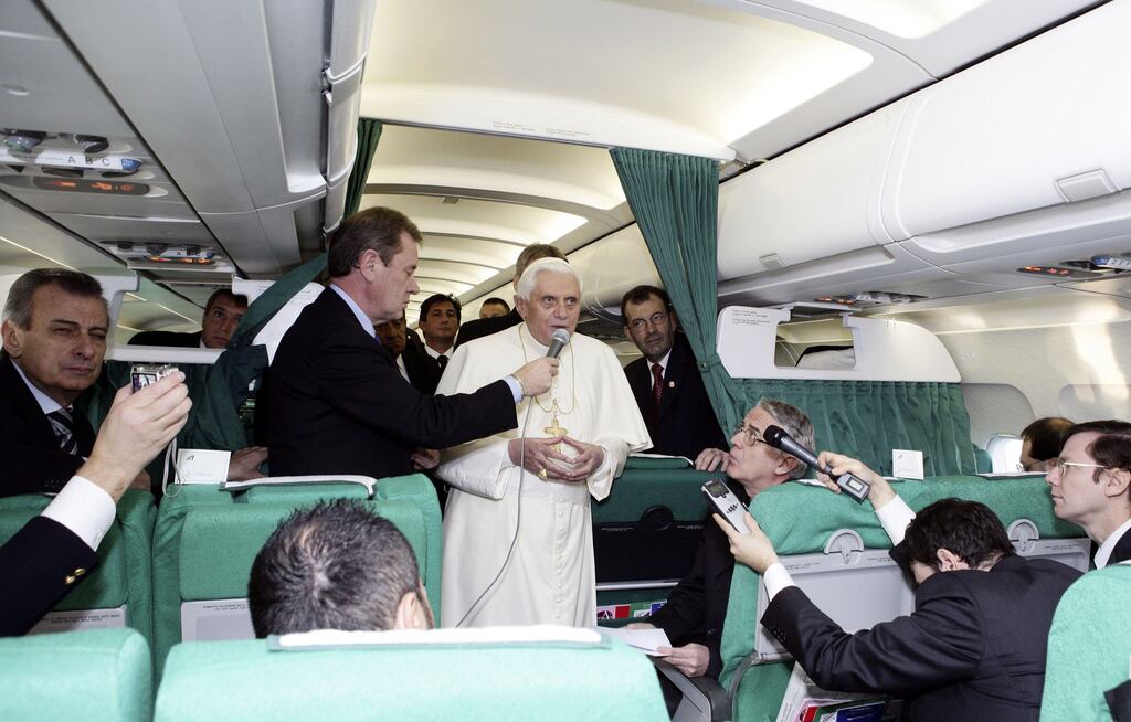 Pope Benedict talks to journalists onboard an aeroplane in Rome before flying to Ankara in 2006.  Photograph: Vatican Pool/Getty Images