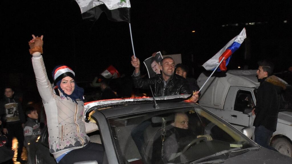 Supporters of the Syrian government celebrate in Aleppo on Thursday. Photograph: George Ourfalian/AFP/Getty