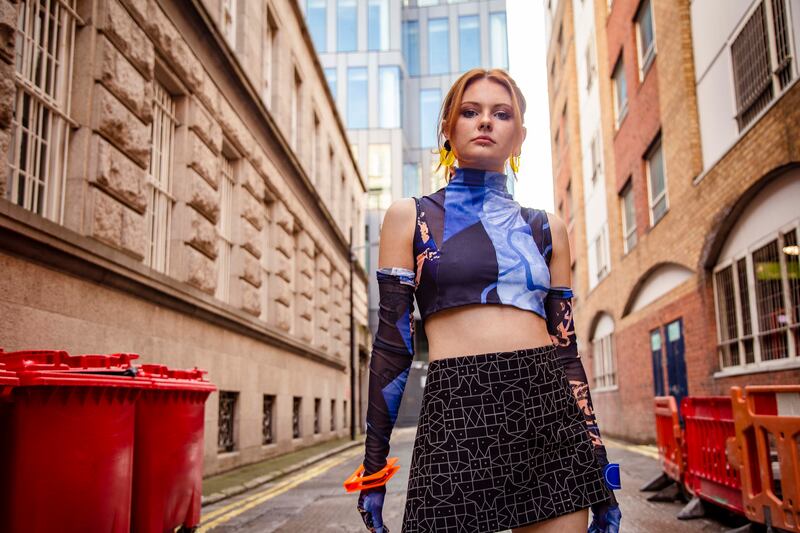 Power mesh top with cutouts €200, gloves €124, both designed and printed by Debekka, black reflective fabric with UV reactive detailing worn as a skirt by Fryday Designs POA, neon etched drop earrings €52 and neon squared cuff €65 both Capulet and Montague. Photograph: Mark Hill