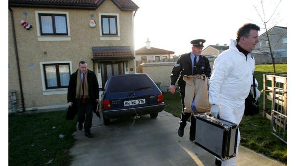 Gardai at the home of Evelyn Joel at Cluainn Dara, Enniscorthy following her death in January, 2006. Photograph: Bryan O'Brien.