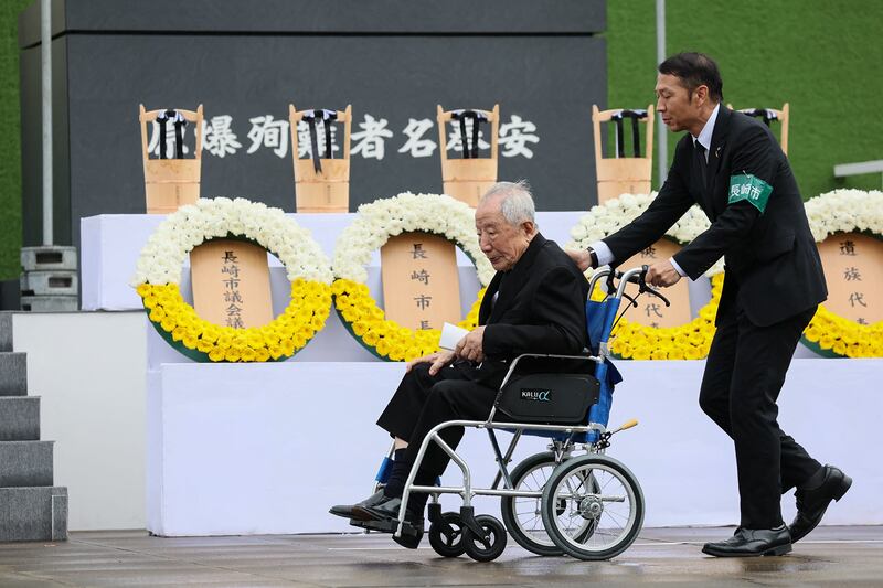 Atomic bomb survivor, or "hibakusha", Hiroshi Nishioka (L), prepares to speak as a representative of survivors during the ceremony. Photograph: Str/Jiji Press/AFP/Getty Images