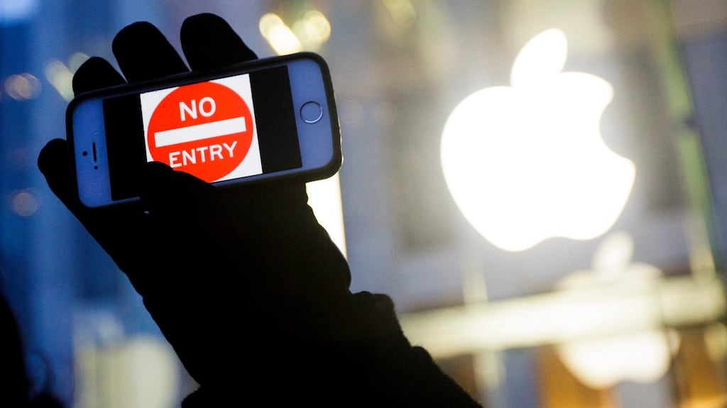 February 2016:  a man holds up an iPhone displaying a “No Entry” image as part of a rally in front of an Apple store in New York in support of the company’s privacy policy. Photograph: Justin Lane/EPA