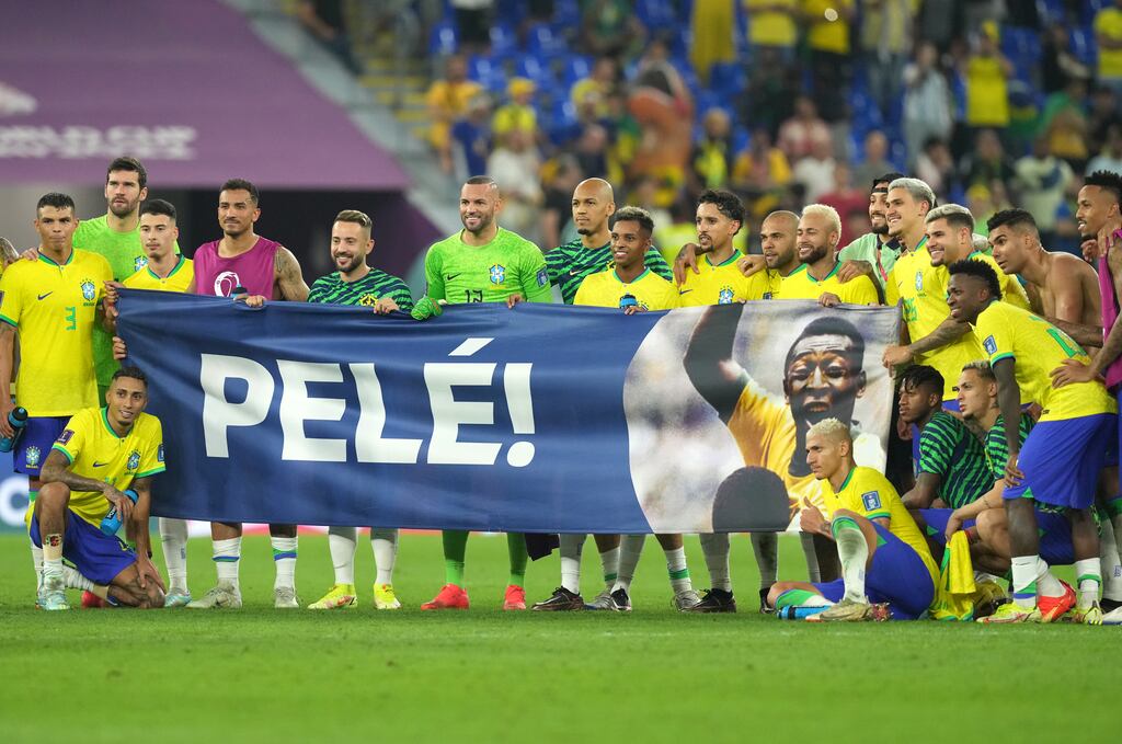 Brazil players bring a Pelé banner on to the pitch following their World Cup match against South Korea in Doha, Qatar. Photograph: PA Images