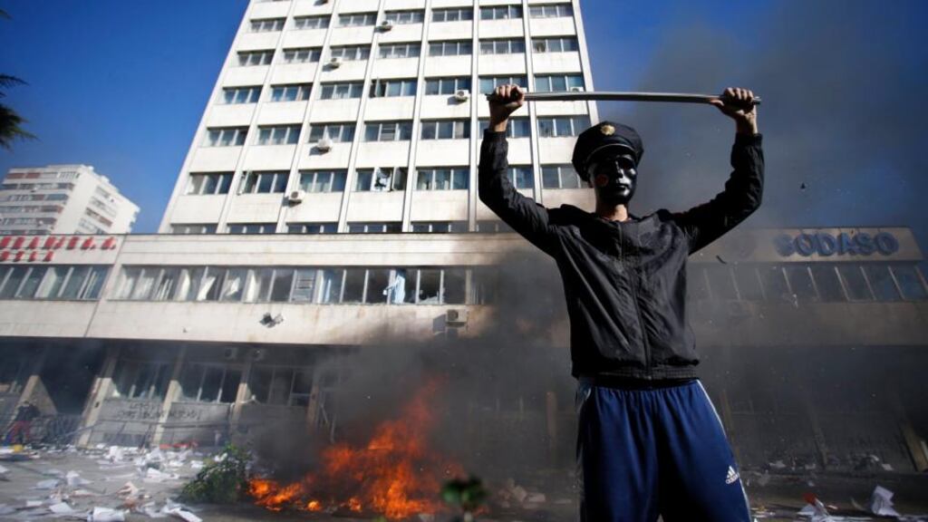 A protester stands near a fire set in front of a government building in Tuzla today as Bosnians protest over job shortages and political inertia. Photograph: Dado Ruvic/Reuters.